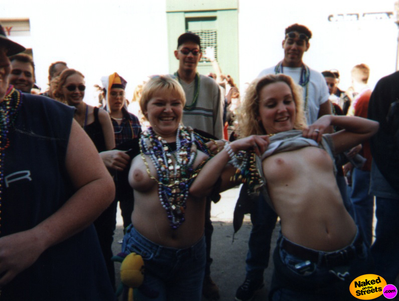 Two rather ugly chicks flashing their boobies at Mardi Gras!