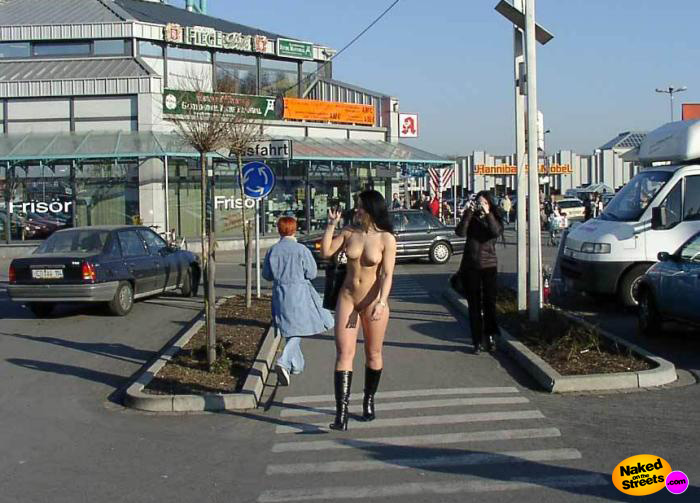 Hot chick crossing the street fully nude near some shops