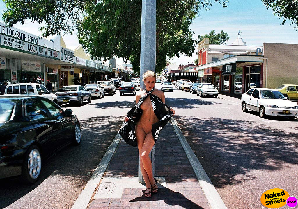 Gorgeous girl showing what's under her dress in the middle of a busy street!!