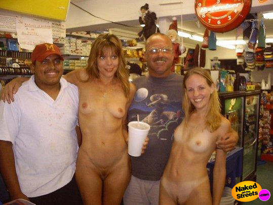 Two lucky guys getting their picture taken with two exhibitionist chicks