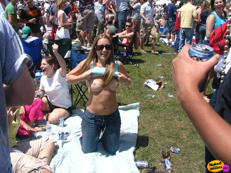 Hot girl flashing her nice tits on the grass at a rockfest