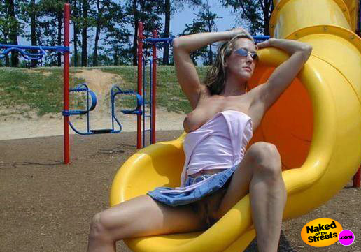 Big boobed girl shows off her boob on a slide