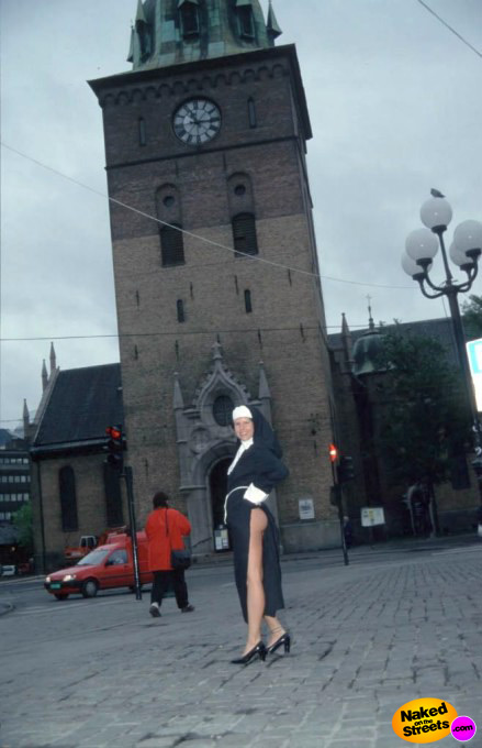 Naughty nun lifts up her dress and shows her ass in public