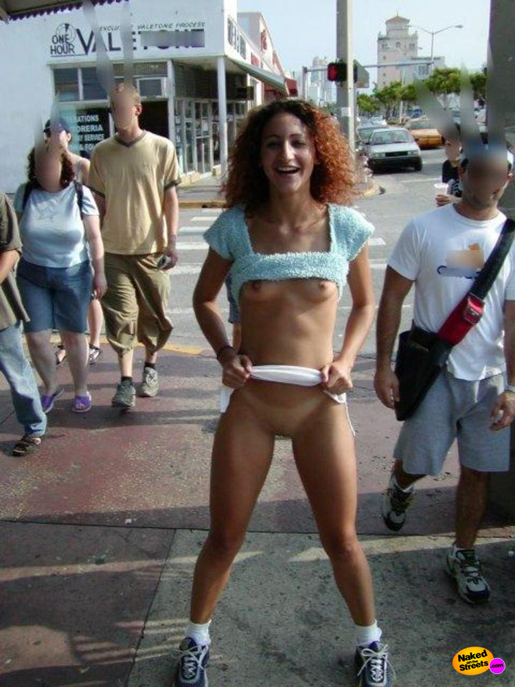 Curly haired cutie flashes snatch in the middle of the street
