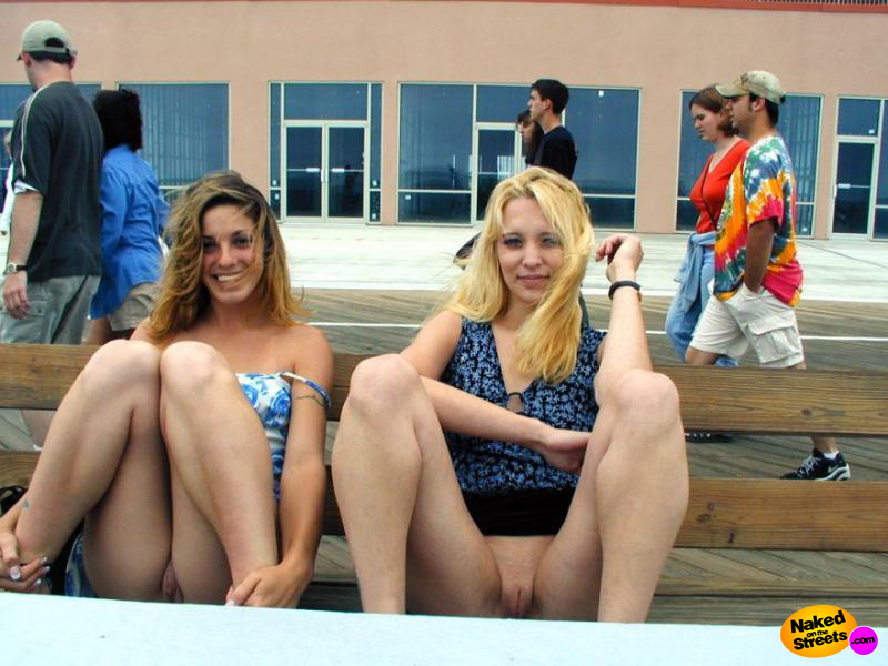 Two crazy college chicks flashing their pussies on a bench on the pier