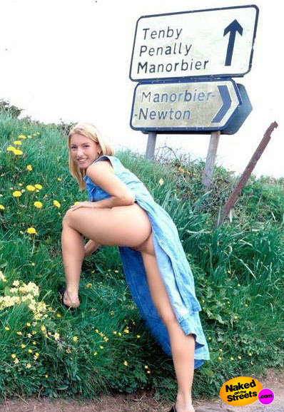 Hot blonde girl shows her ass at a road sign