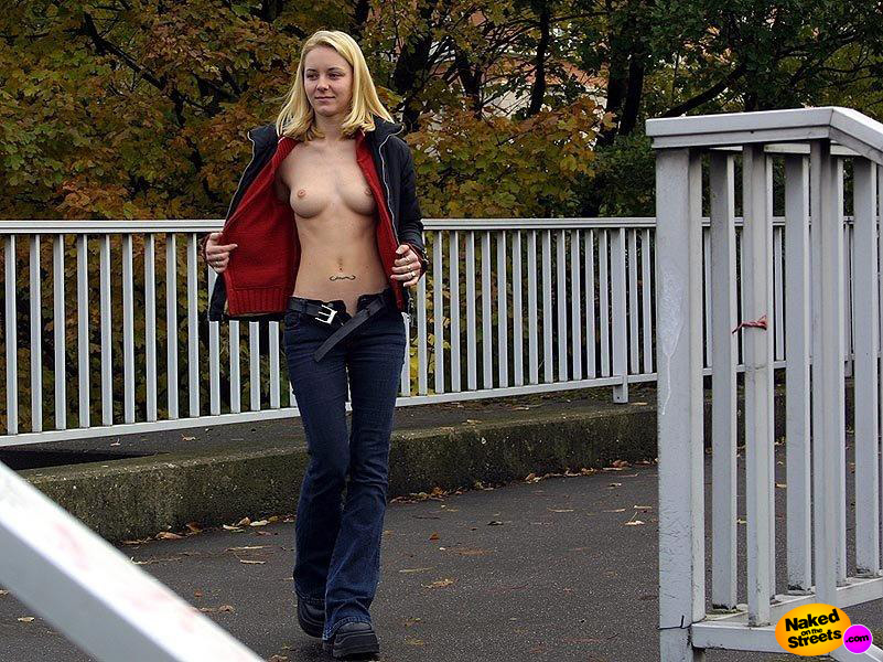Super fit hot blonde chick showing her tits while walking outside
