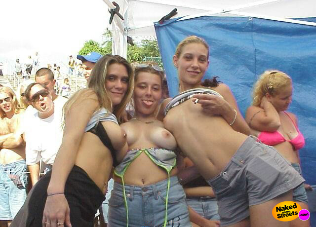 Three girls show off their boobs at a festival