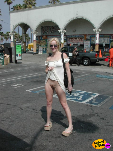 Blonde fashion whore shows off her snatch on the parking lot