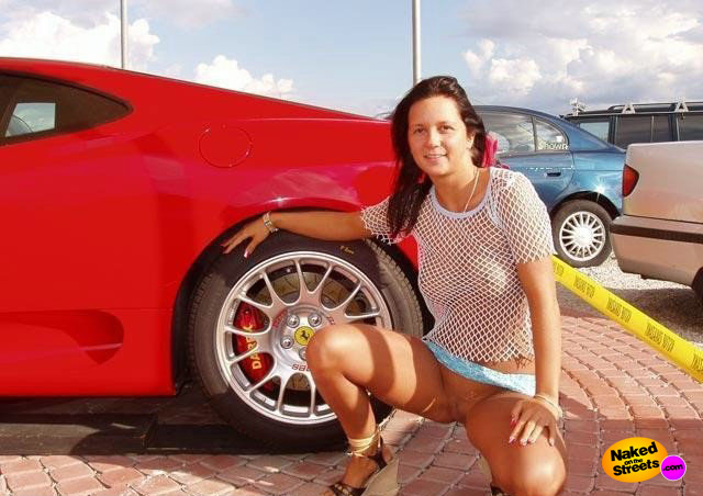 Hot chick poses next to a Ferrari.. I'd take the car!