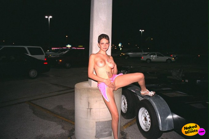 Short haired slut posing at a car park in the night