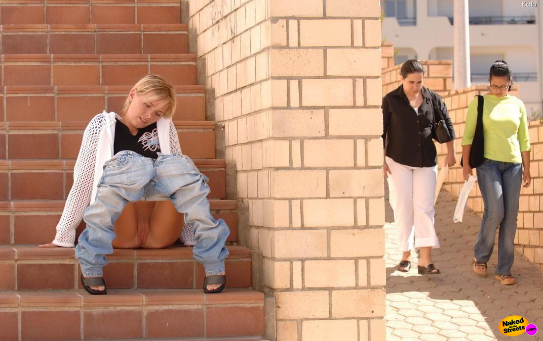 Fucking slutty blonde teen flashes her hot pussy while sitting on some stairs