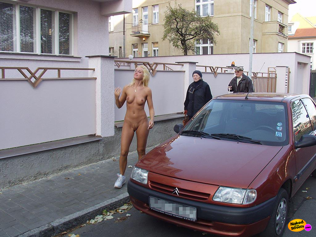 Sexy blonde whore shows off her sexy body right on the streets
