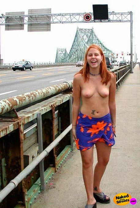 Nerdy looking ho shows her tits on a bridge