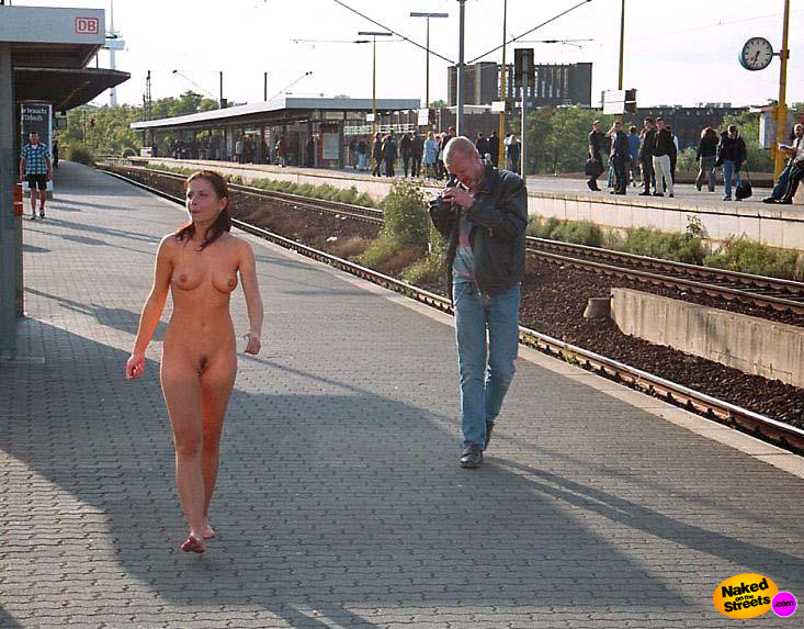 Sexy girl posing on the sidewalk with no clothes on