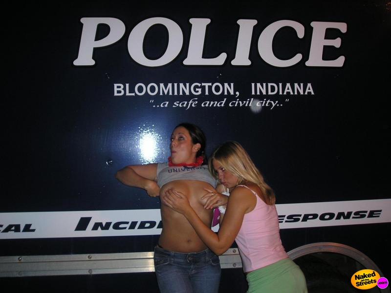 Two drunk sluts flash their titties next to a special police vehicle