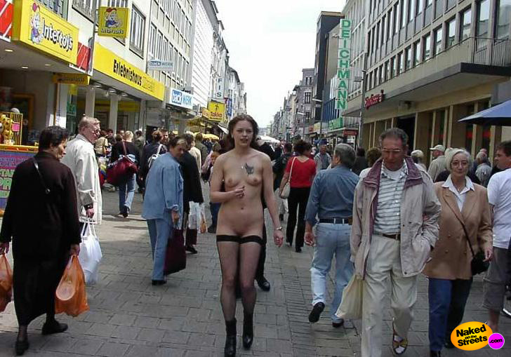 Tall chick walking through a shopping crowd with no clothes at all