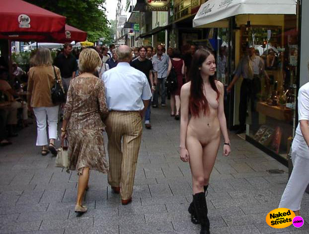 Very young dark haired chick walking on the streets fully naked