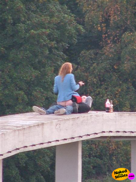 Crazy couple fucking on top of a pretty high bridge