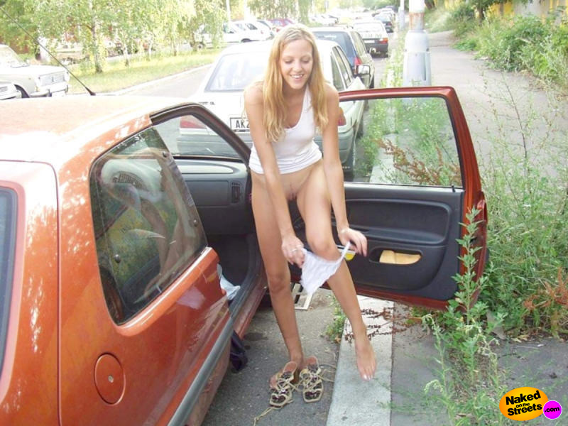 Sexy young teen undressing next to her car, flashing her pussy in the process