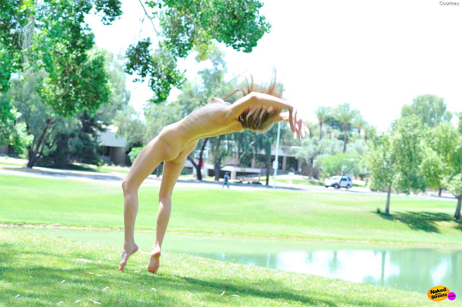 Girl doing naked cartwheels at the park