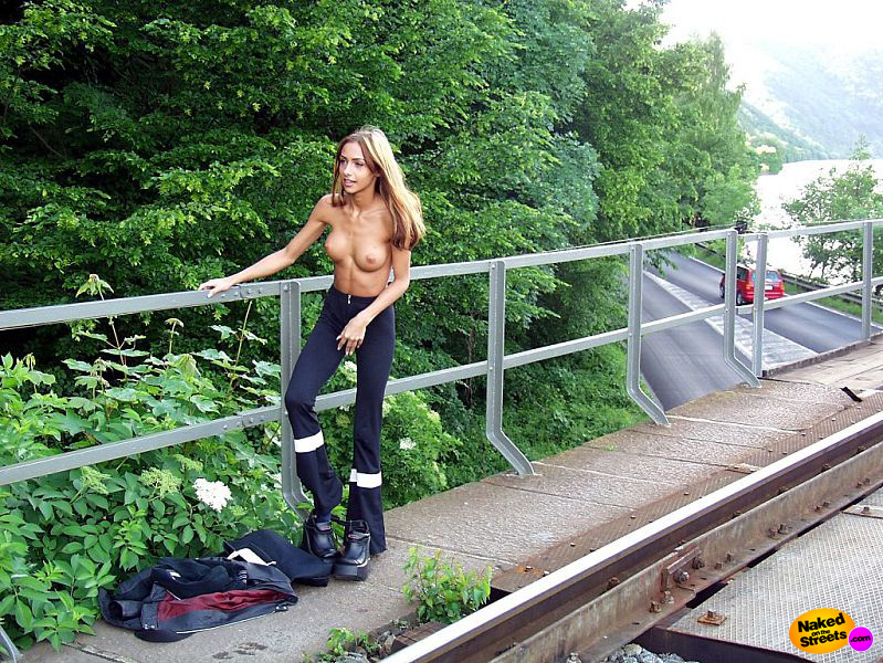 Skinny slut undressing on a highway overpass