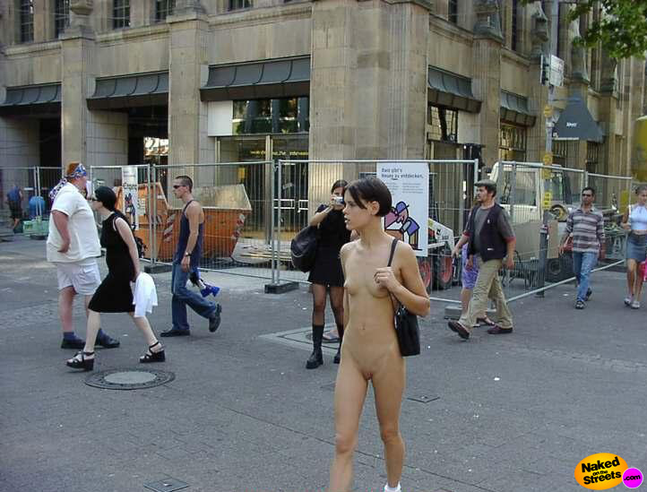 Sexy shorthaired teen walking on the streets fully nude
