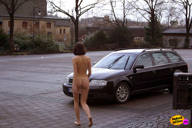 Naughty girl shows off her ass on a parking lot
