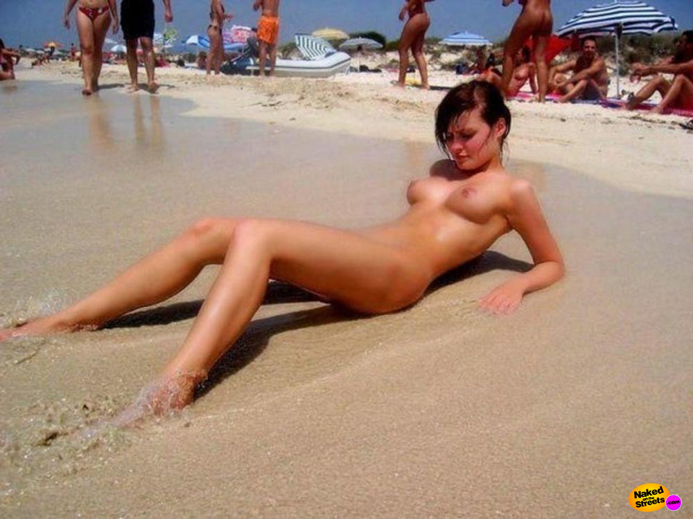 Perky boobed teen laying around on the beach