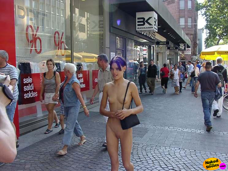 Purple haired skinny teen shows off her body in the city