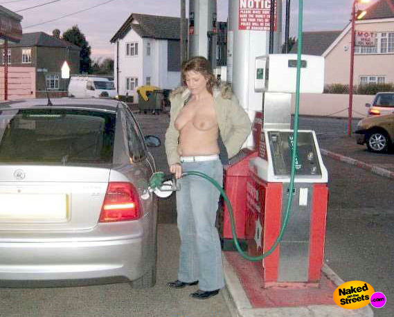 Chick shows off her tits while she gets some gas