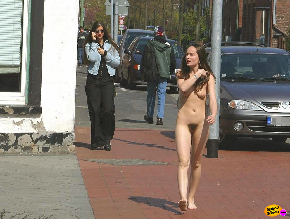 Small teen chick with a retro 70s bush walks nude on the street