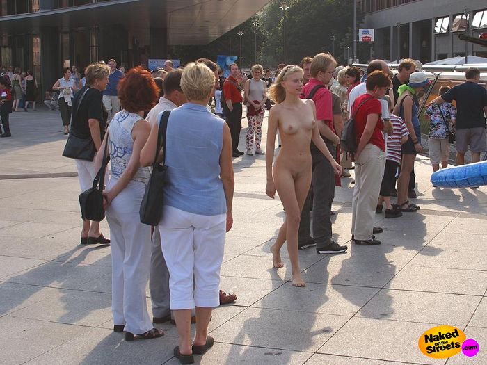 Naughty blonde amateur teen walking through a crowd in the city