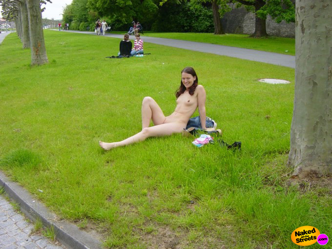 Naughty girl lays around in the grass naked