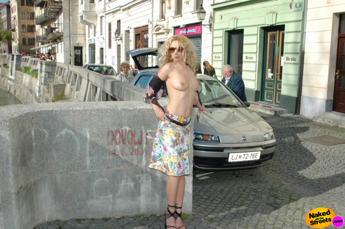 Crazy girl goes topless in a busy street