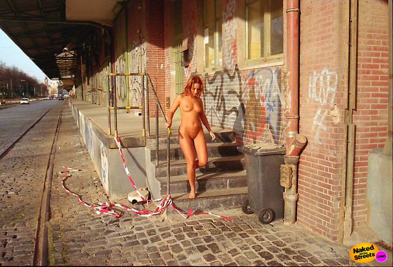 Sexy teen chick walks around naked in the slums
