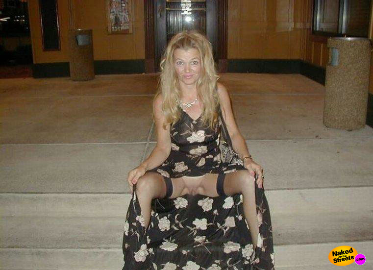Blonde milf shows her snatch on the stairs 