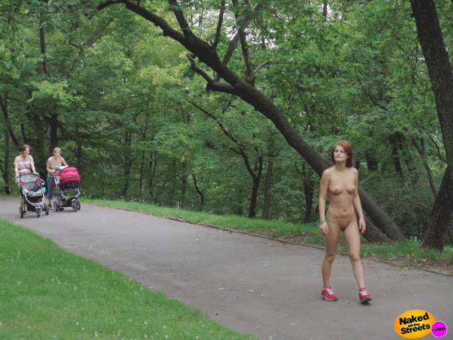 Redhead girl with red sneakers walks around fully nude in the park