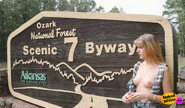 Milf shows off her boobies next to a park sign