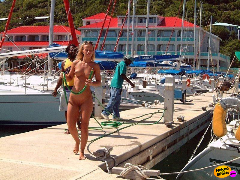 Hot blonde chick walking fully nude at the docks on a tropical island