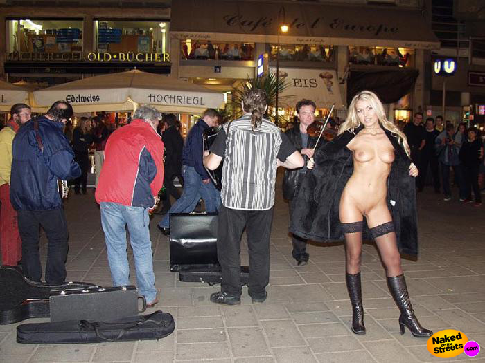 Very sexy blonde flashing her perfect body in front of some street musicians