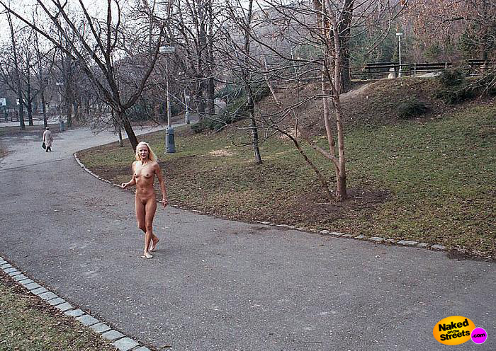 Blonde girl walks around naked in a public park