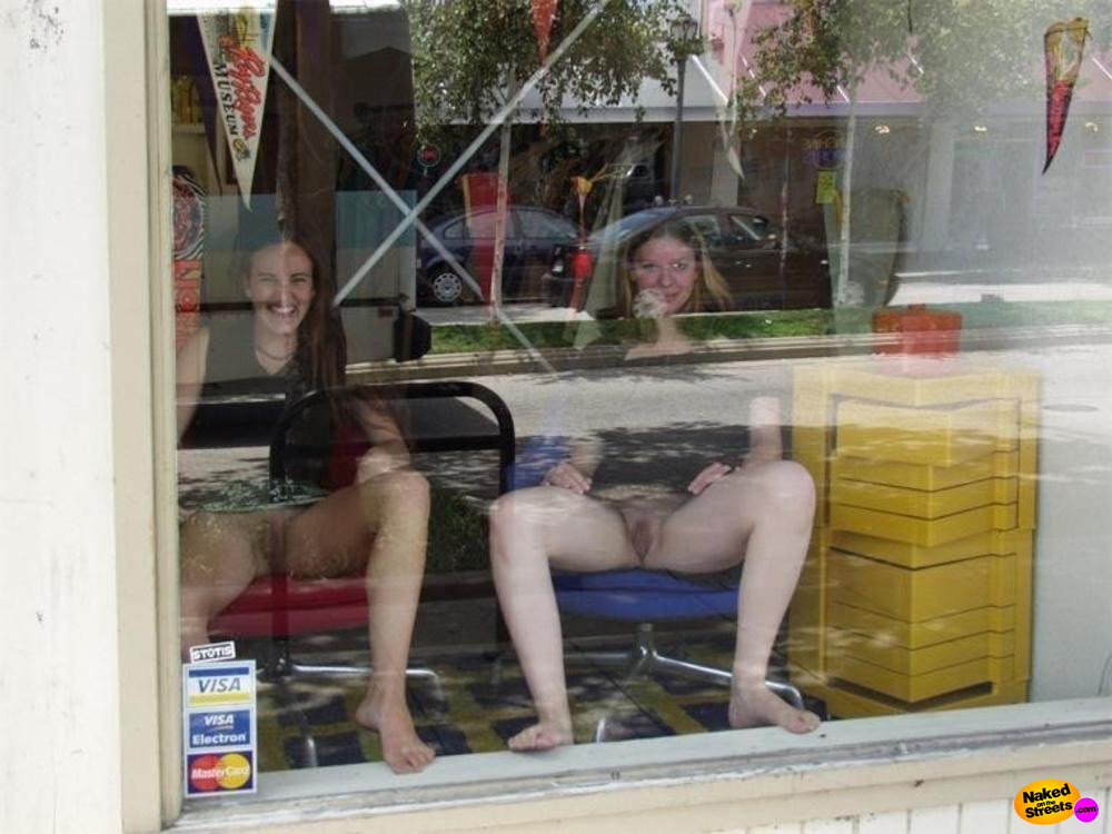 Naughty girls show their pussies off behind a window