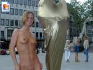 Short haired blonde milf shows off her body next to an egyptian statue