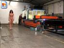 Naughty slut walks around naked in a factory