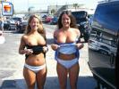 Two slutty whores show off their titties in the street