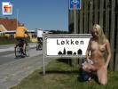 Super hot blonde flashing next to a town sign