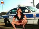 Kinky chick flashes pussy in front of a squad car