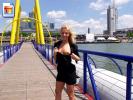 Hot blonde girl flashes her boobie on a bridge