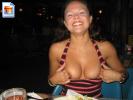 Crazy milf shows off her tits at dinner